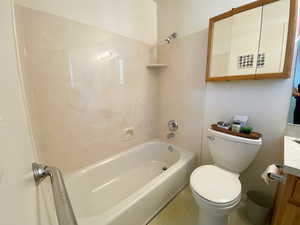 Full bath featuring vanity and washtub / shower combination