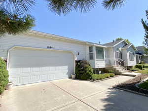 View of front facade featuring driveway and an attached garage