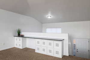 Detailed view of carpet flooring and baseboards