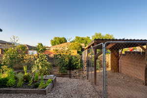 View of yard with a garden and a gate