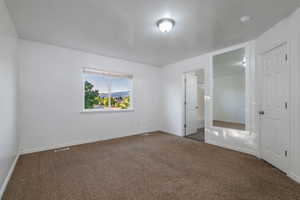 Unfurnished bedroom with carpet flooring