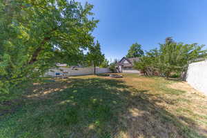 Fenced backyard featuring a fire pit