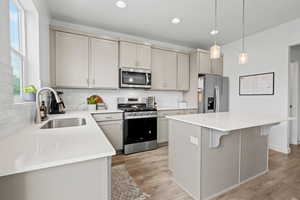 Kitchen with appliances with stainless steel finishes, backsplash, a kitchen bar, a kitchen island, and recessed lighting