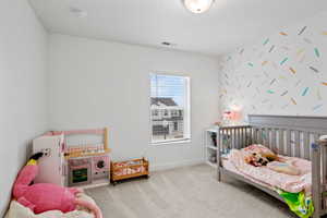 Carpeted bedroom with a walk-in closet