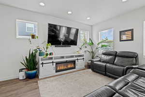 Living room featuring recessed lighting and wood-style laminate floors