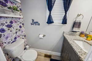 Bathroom featuring vanity and wood finished floors