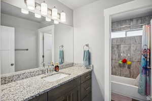 Full bath featuring vanity and shower / bath combo with shower curtain