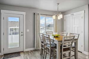 Dining area featuring a chandelier and light wood-type flooring