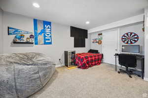 Carpeted bedroom featuring recessed lighting and a textured ceiling