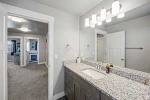 Bathroom with vanity and baseboards