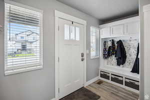 Mudroom with baseboards and wood finished floors