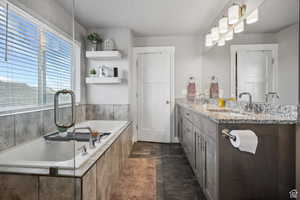 Full bath with double vanity and a bath