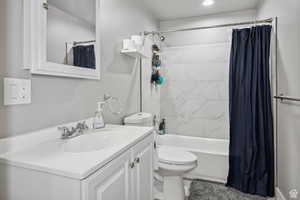 Full bath featuring vanity, shower / tub combo, and recessed lighting