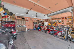 Garage featuring a workshop area and a garage door opener