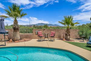 View of pool with a mountain view and a patio
