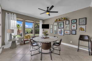 Dining area featuring light tile patterned floors and a ceiling fan
