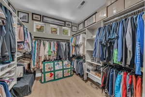 Walk in closet featuring wood finished floors
