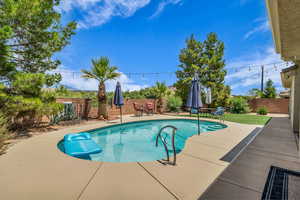 View of pool with a patio area and a fenced backyard