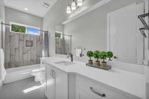 Bathroom featuring vanity, tub / shower combination, and tile patterned floors