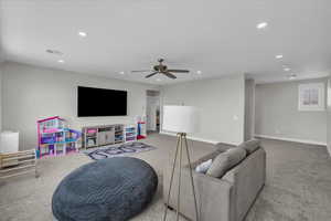 Living area with recessed lighting, carpet, and a ceiling fan