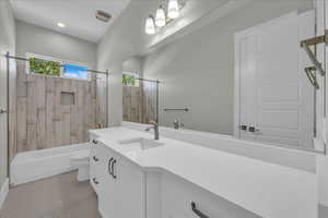 Bathroom with shower / bath combo, vanity, and tile patterned floors