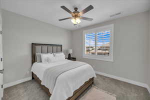 Carpeted bedroom featuring baseboards and a ceiling fan