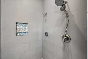 Bathroom featuring tiled shower