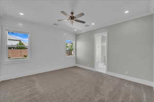 Unfurnished room with light carpet, recessed lighting, a ceiling fan, wood walls, and ornamental molding