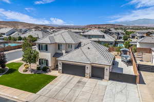 View of front of property featuring stucco siding, a residential view, and a garage