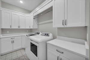 Washroom with washer and clothes dryer, cabinet space, and recessed lighting