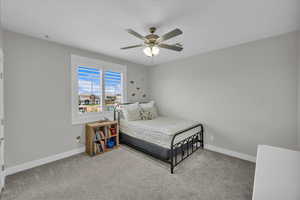 Bedroom with carpet and a ceiling fan
