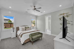 Bedroom featuring light carpet, recessed lighting, ceiling fan, and connected bathroom
