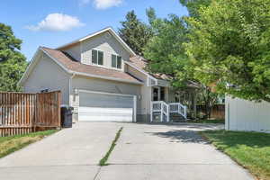 Traditional-style house with concrete driveway and roof with shingles