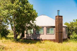 View of property exterior with a chimney