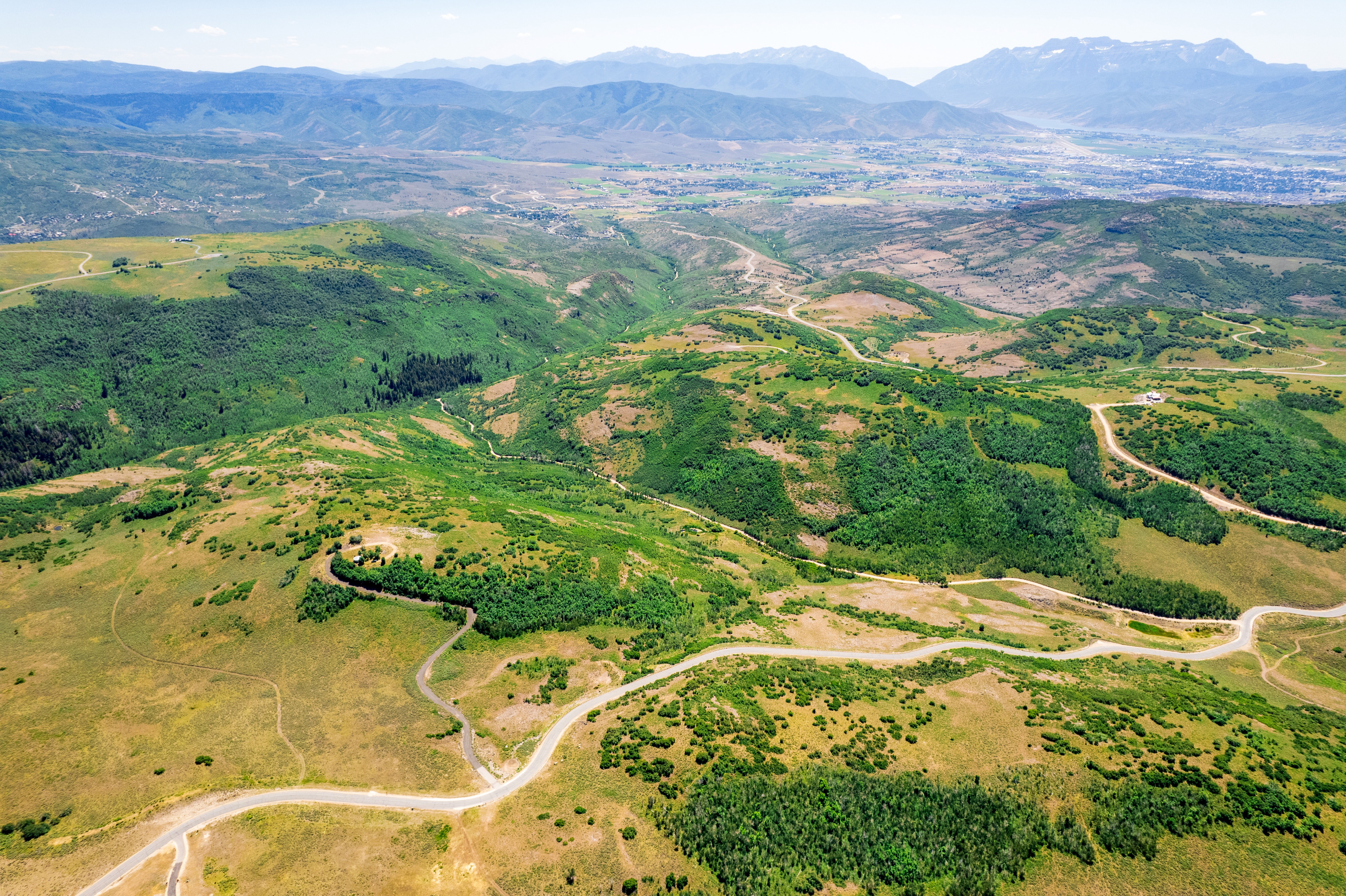 Aerial view of property and surrounding area featuring mountains