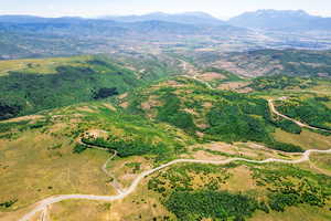Aerial view of property and surrounding area featuring mountains