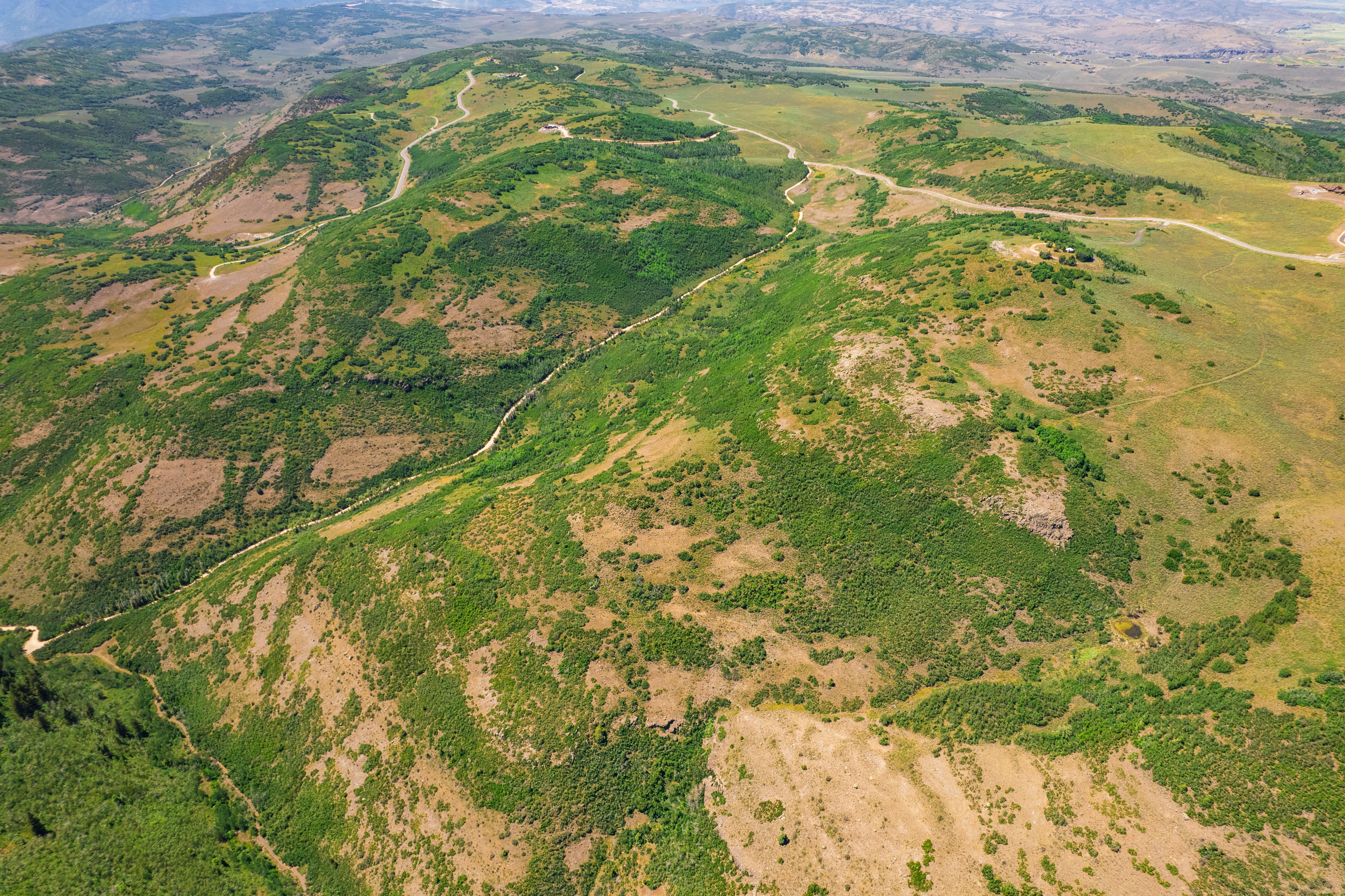 Aerial overview of property's location featuring a mountainous background