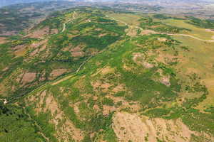 Aerial overview of property's location featuring a mountainous background