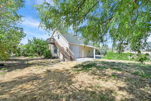 View of property exterior featuring stairs and a deck