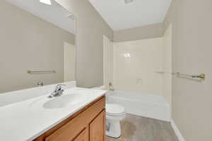 Full bath featuring vanity, tile patterned flooring, and shower / bath combination