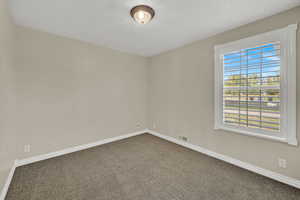 Empty room featuring carpet flooring