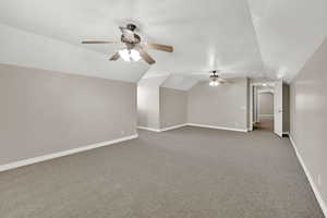 Bonus room with a ceiling fan, carpet, and lofted ceiling