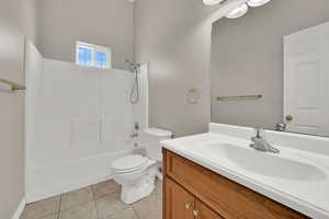 Bathroom with vanity, tile patterned floors, and bathing tub / shower combination