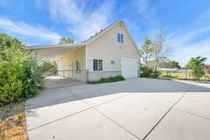 View of property exterior with driveway and brick siding