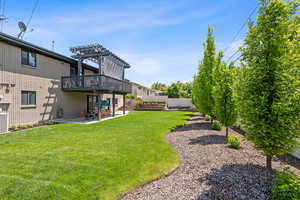View of yard with a pergola, a patio, and a deck