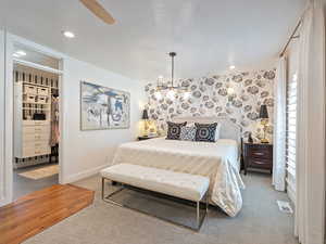 Bedroom with carpet, a spacious closet, and recessed lighting