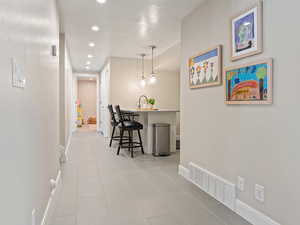 Hallway featuring recessed lighting and tile patterned flooring