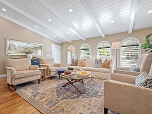 Living room with light wood finished floors and recessed lighting
