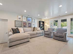 Living room featuring french doors, recessed lighting, and a textured ceiling