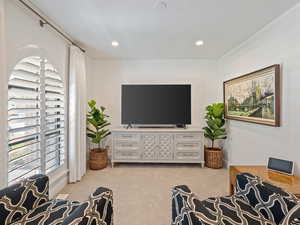 Carpeted living area with recessed lighting